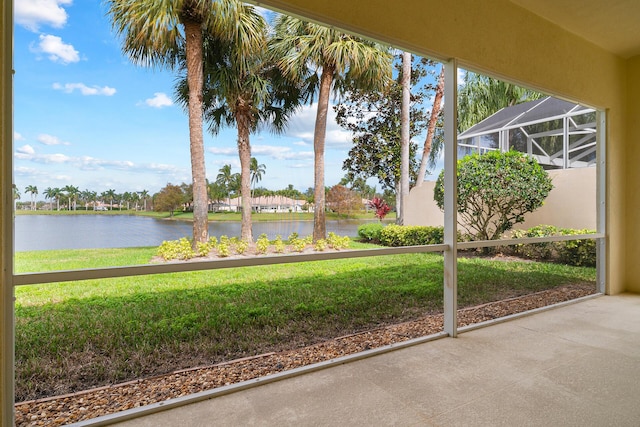 unfurnished sunroom featuring a water view