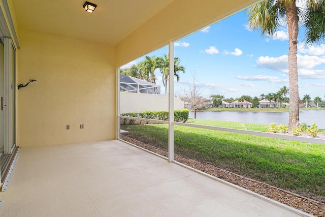 unfurnished sunroom with a water view