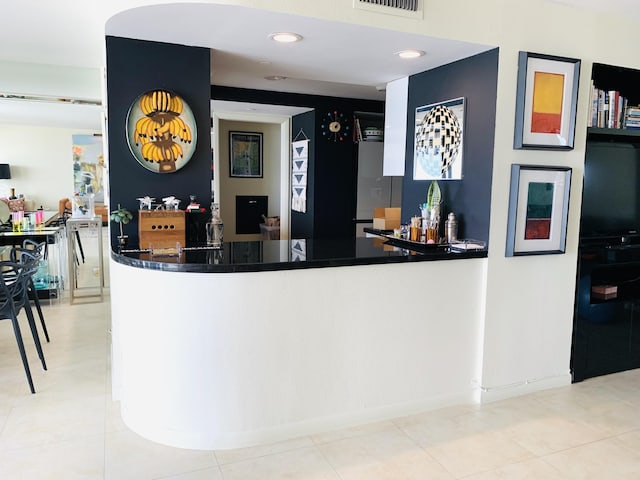 bar featuring light tile patterned flooring