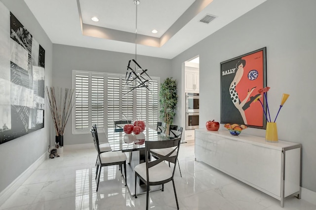 dining area featuring a raised ceiling