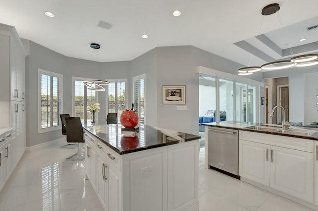 kitchen featuring white cabinetry, sink, dishwasher, and a kitchen island with sink