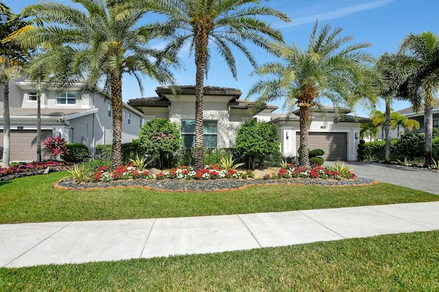 view of front facade with a garage and a front yard