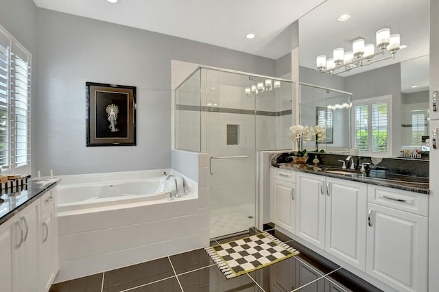 bathroom featuring vanity, shower with separate bathtub, a chandelier, and tile patterned flooring