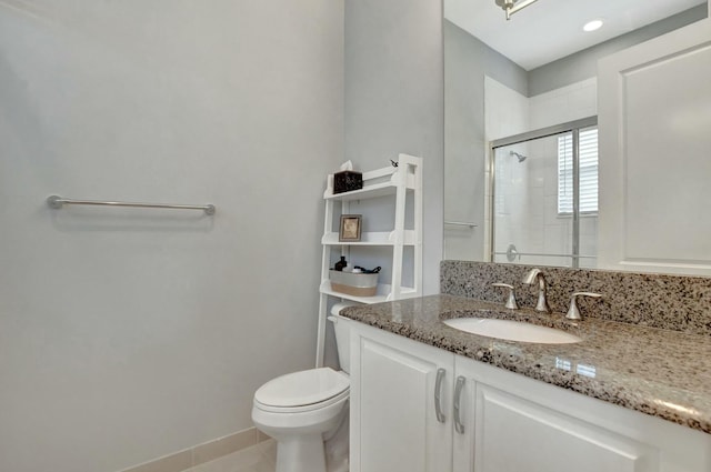 bathroom with vanity, tile patterned flooring, a shower with shower door, and toilet