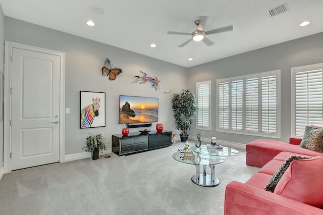 carpeted living room featuring ceiling fan