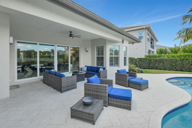 view of patio / terrace with ceiling fan, outdoor lounge area, and a fenced in pool