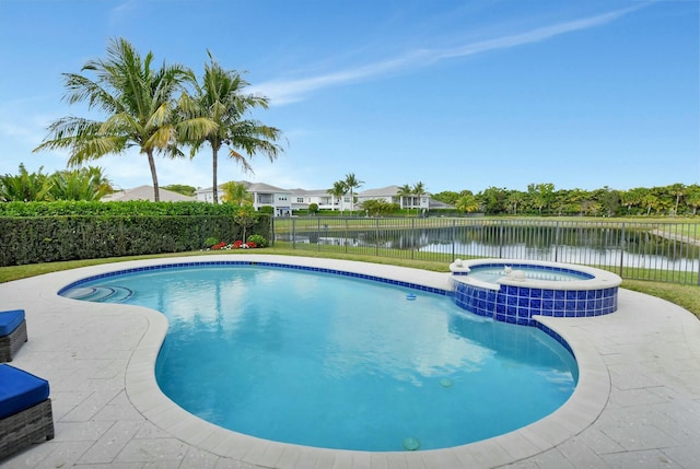 view of swimming pool featuring an in ground hot tub and a water view