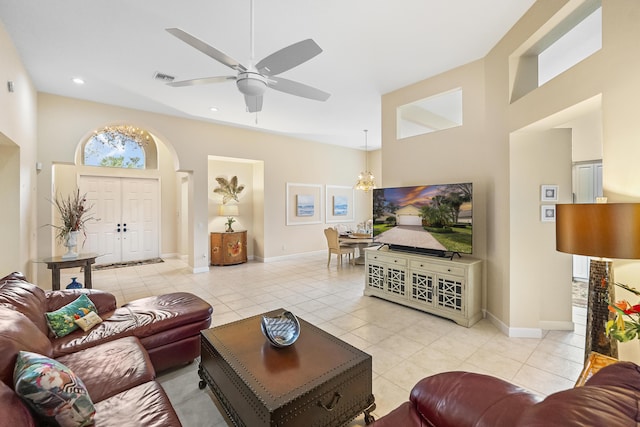 living room with visible vents, ceiling fan with notable chandelier, recessed lighting, light tile patterned floors, and baseboards