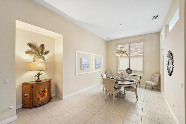 dining room featuring light tile patterned floors, visible vents, baseboards, and an inviting chandelier