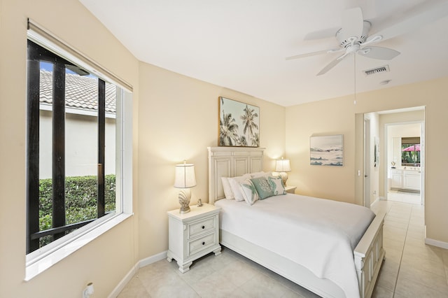 bedroom with light tile patterned floors, visible vents, baseboards, and ceiling fan