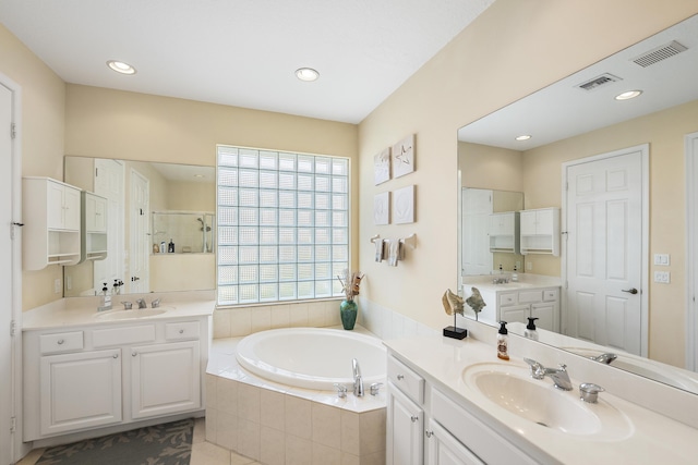 bathroom featuring a sink, visible vents, a stall shower, and a bath