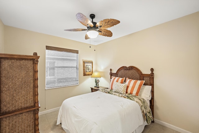 bedroom with light tile patterned floors, visible vents, a ceiling fan, and baseboards