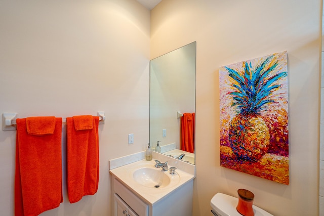 bathroom with toilet and vanity