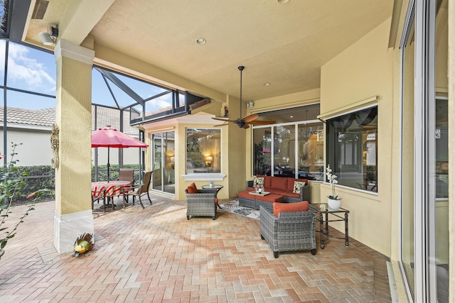 view of patio / terrace featuring outdoor lounge area, a lanai, and a ceiling fan