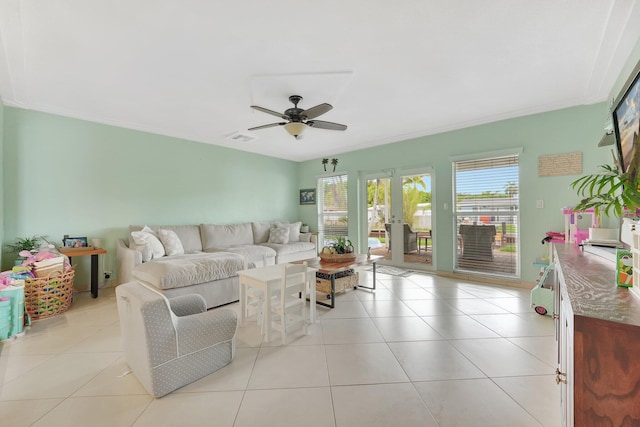 living room featuring light tile patterned flooring, ceiling fan, and french doors