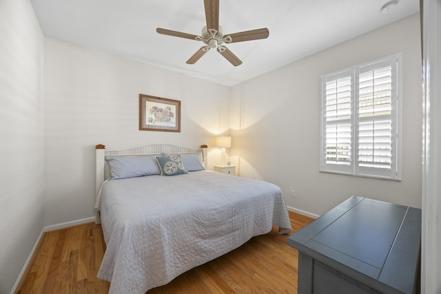 6301 SE Turn Leaf Trl, Hobe Sound, FL 33455 - bedroom with light wood-type flooring, ceiling fan, and baseboards