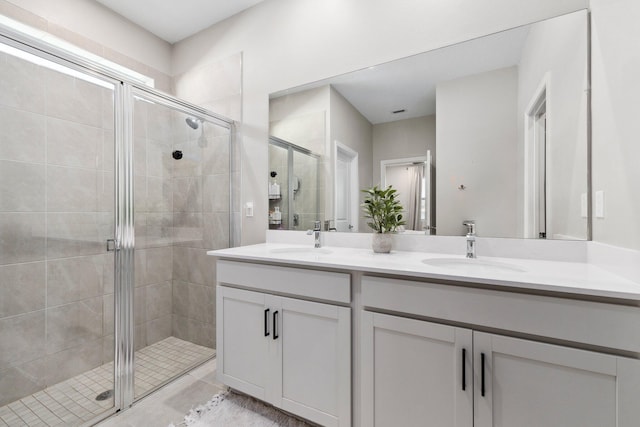 bathroom featuring vanity and an enclosed shower