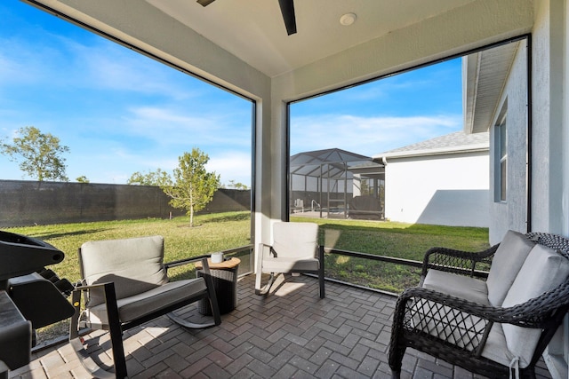 sunroom featuring ceiling fan