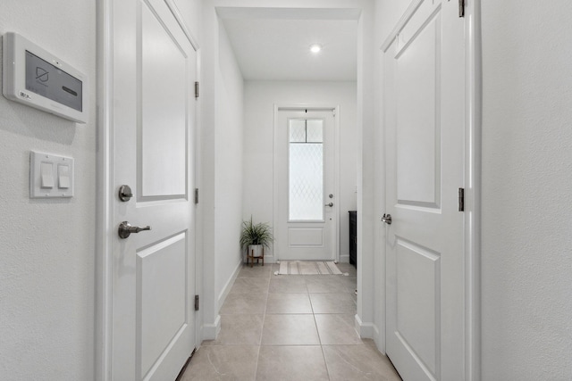 doorway featuring light tile patterned flooring