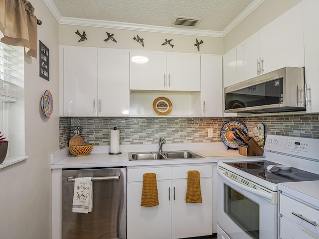 kitchen featuring white cabinetry, appliances with stainless steel finishes, sink, and ornamental molding