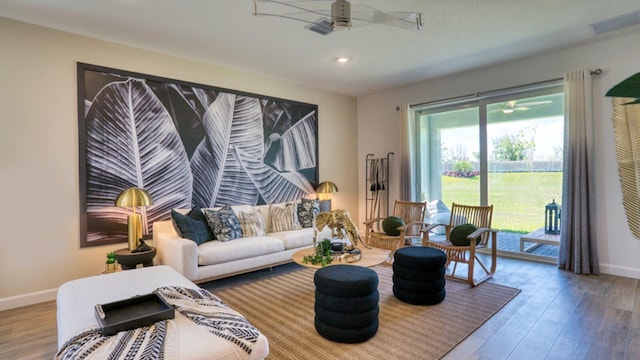 living room with hardwood / wood-style flooring and ceiling fan