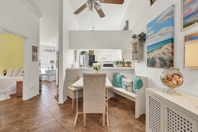 tiled dining space with ornamental molding, a textured ceiling, and ceiling fan