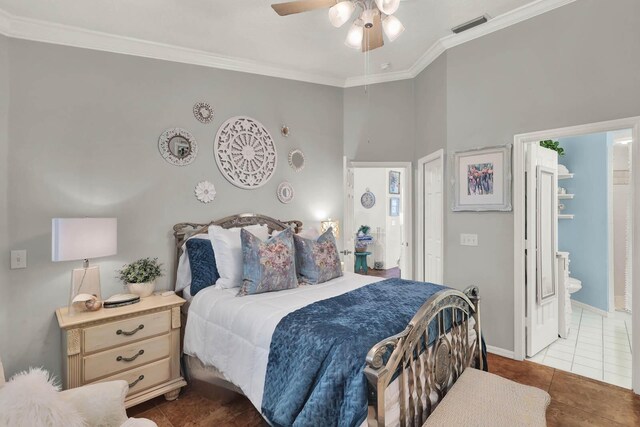 tiled bedroom featuring crown molding, ceiling fan, and ensuite bath