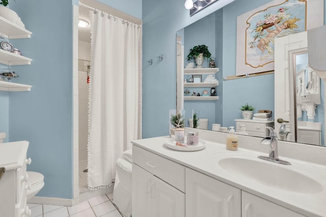 bathroom featuring tile patterned flooring, vanity, toilet, and walk in shower