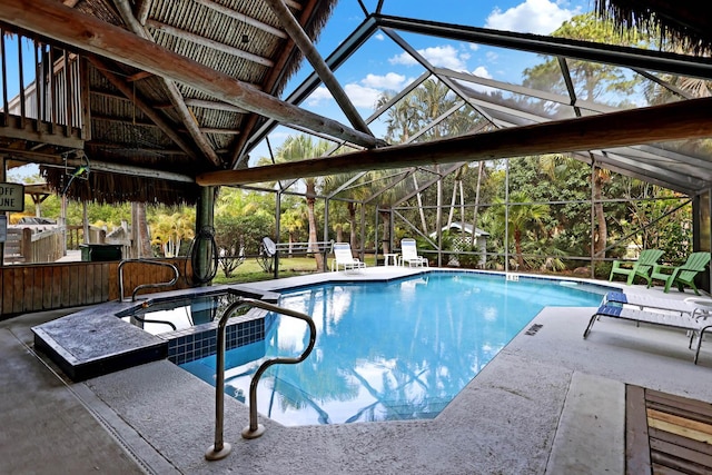 view of swimming pool featuring exterior bar, a lanai, and a patio area