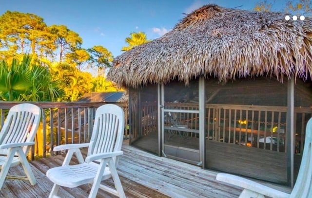 wooden deck with a sunroom