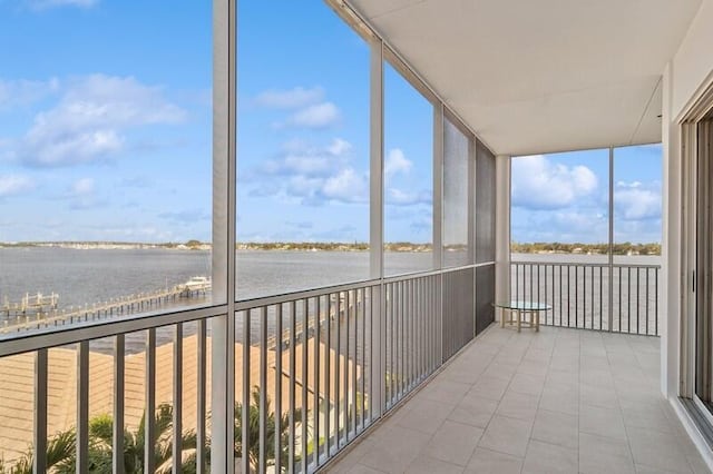 unfurnished sunroom featuring a water view and a healthy amount of sunlight