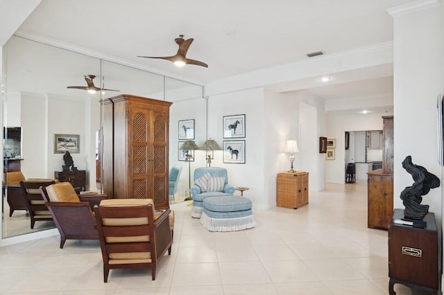 sitting room featuring crown molding, ceiling fan, and light tile patterned floors