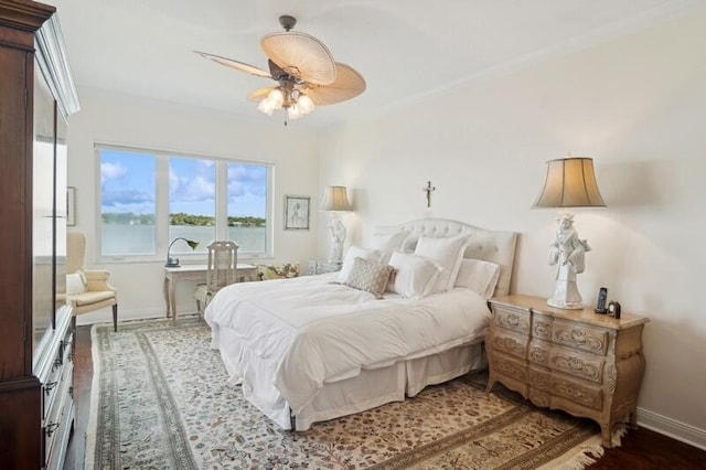 bedroom with crown molding, ceiling fan, and hardwood / wood-style floors