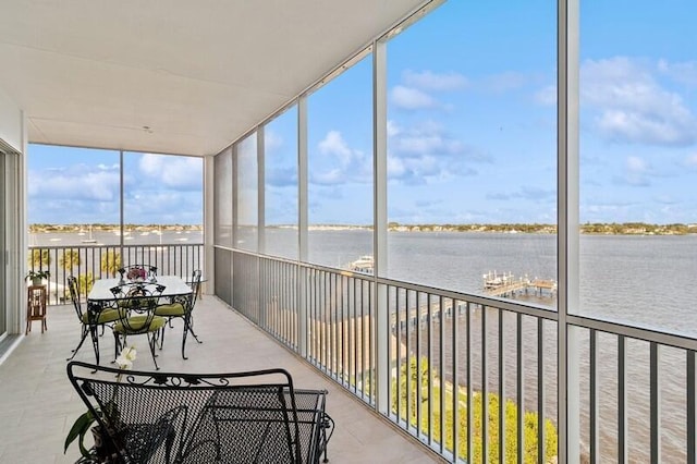 unfurnished sunroom with a water view