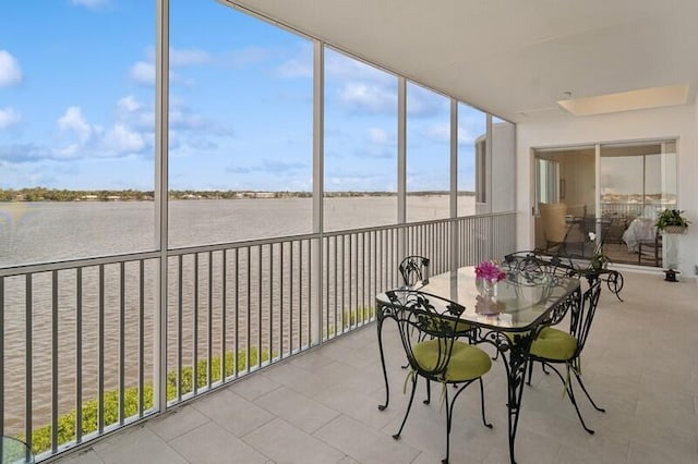 unfurnished sunroom with a water view