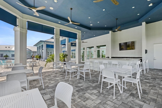 view of patio with ceiling fan and exterior bar