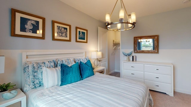 bedroom with an inviting chandelier and light carpet