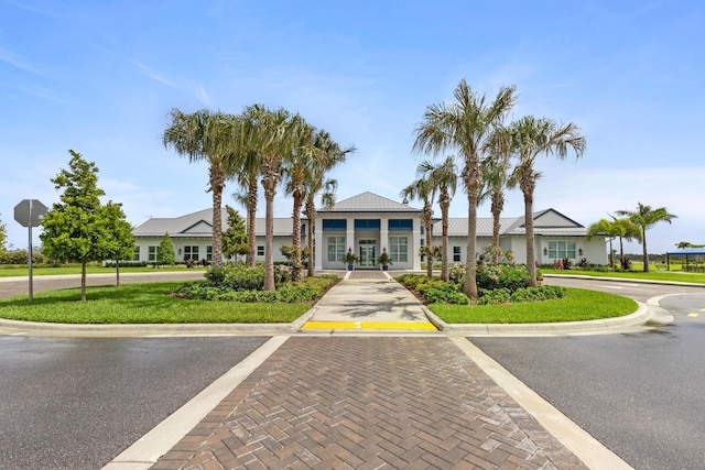 view of front of house with a front yard and french doors