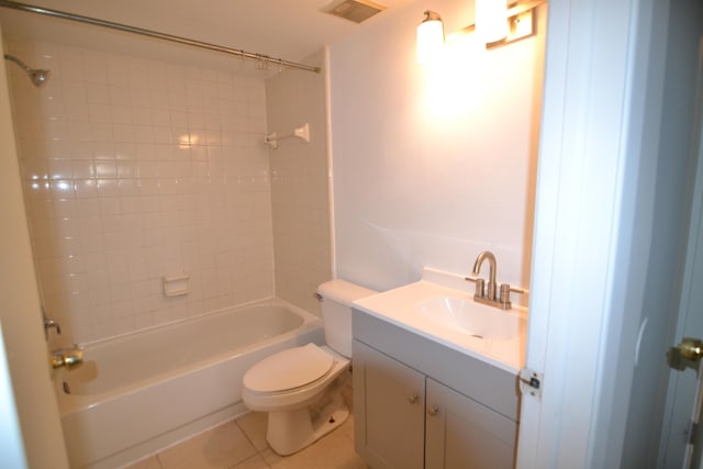 full bathroom featuring tile patterned floors, toilet, vanity, and tiled shower / bath