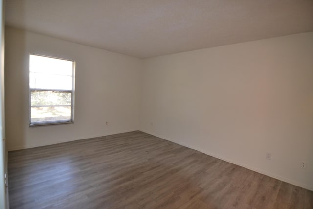 unfurnished room featuring dark hardwood / wood-style flooring