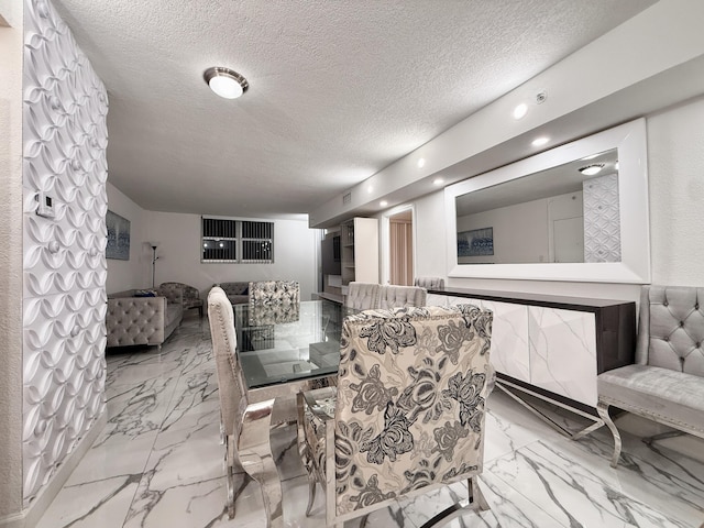 dining space featuring visible vents, marble finish floor, and a textured ceiling