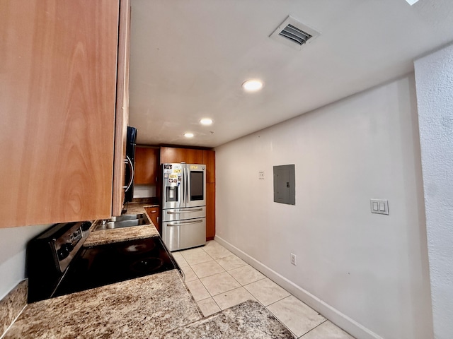 kitchen with electric stove, recessed lighting, stainless steel fridge with ice dispenser, electric panel, and visible vents