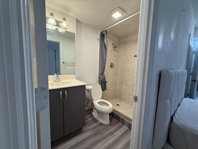 full bath with wood finished floors, a shower stall, toilet, and vanity