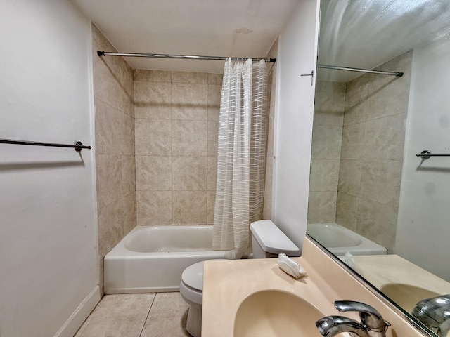 bathroom with a sink, baseboards, shower / tub combo with curtain, toilet, and tile patterned floors