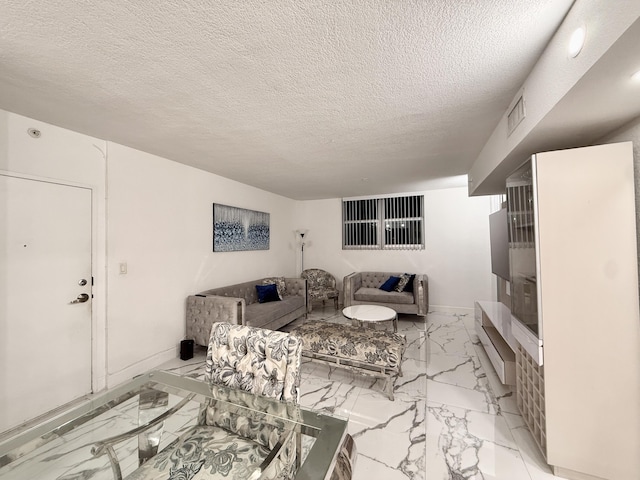 living area with visible vents, baseboards, a textured ceiling, and marble finish floor