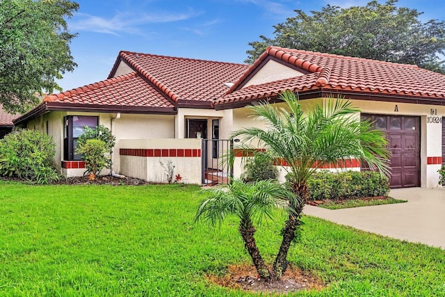 mediterranean / spanish-style house with a garage and a front yard