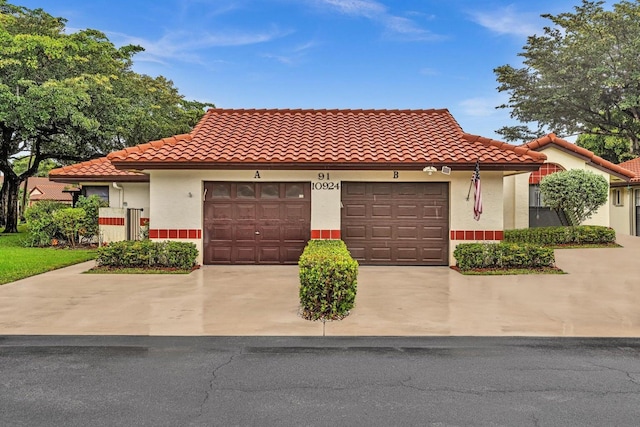 mediterranean / spanish-style home with a garage