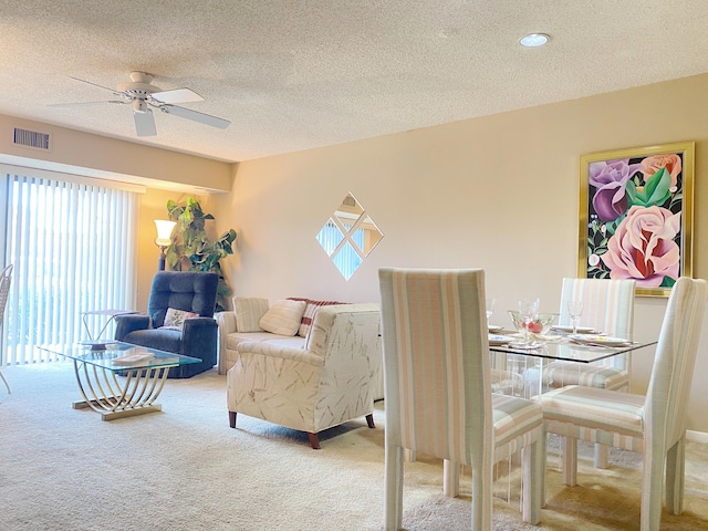 carpeted living room featuring a textured ceiling and ceiling fan