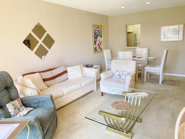 living room featuring carpet floors and a textured ceiling