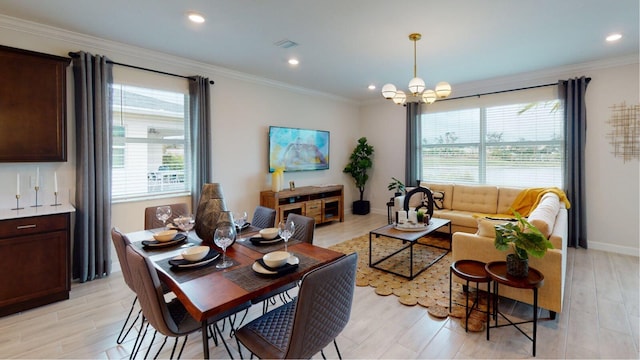 living room with an inviting chandelier, ornamental molding, and light hardwood / wood-style floors